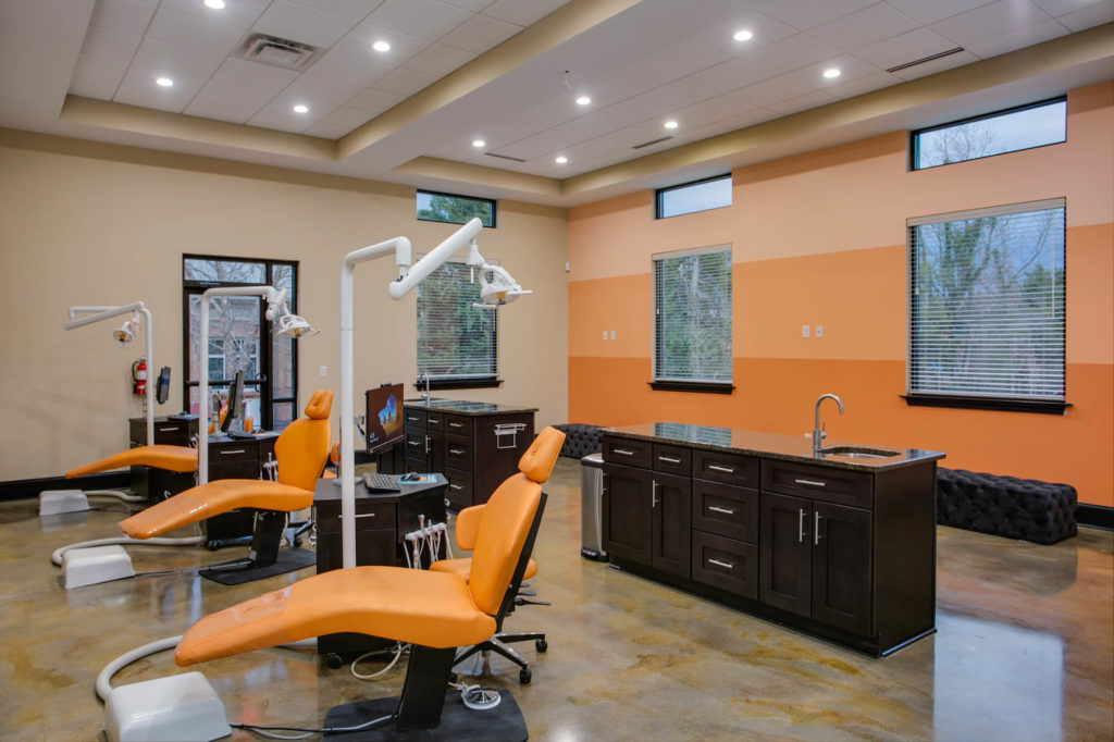 Winston Salem Orthodontist bay with Orange striped wall and orange chairs