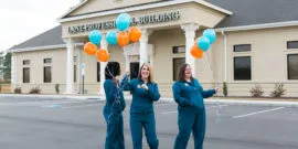 Surgical Assistants holding balloons outside of dental office