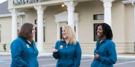 Three dental assistants laughing and talking