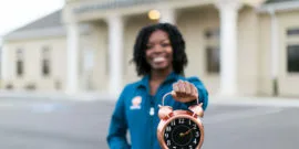 Clock in focus with dental assistant blurred in background