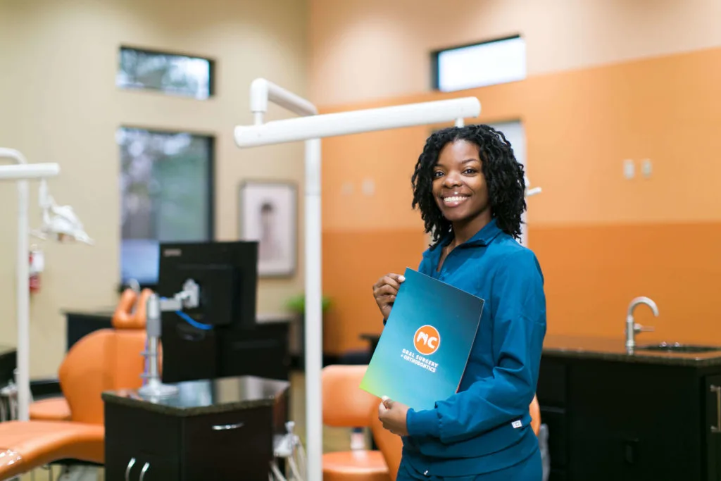 Hamlet NC Orthodontist staff holding folder