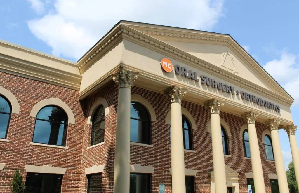 Cary NC orthodontic office two story brick building with cream colored columns 