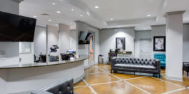 Cary Orthodontist interior Lobby area with gray leather couches and beautiful concrete floor