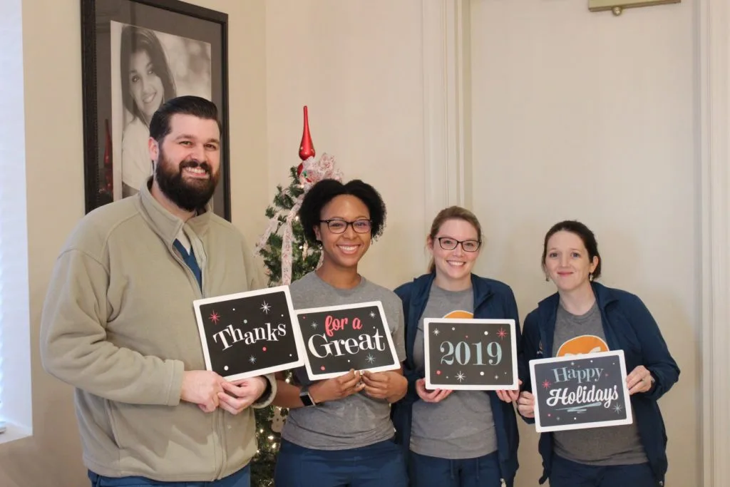 Garner NC Orthodontist team holding New Years signs