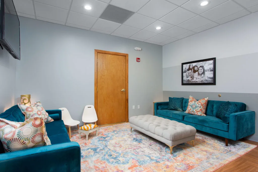 Oral Surgery guest waiting area with couches and TV